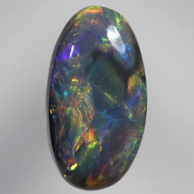 SOLID BLACK OPAL Cherry red and orange over a green/blue background